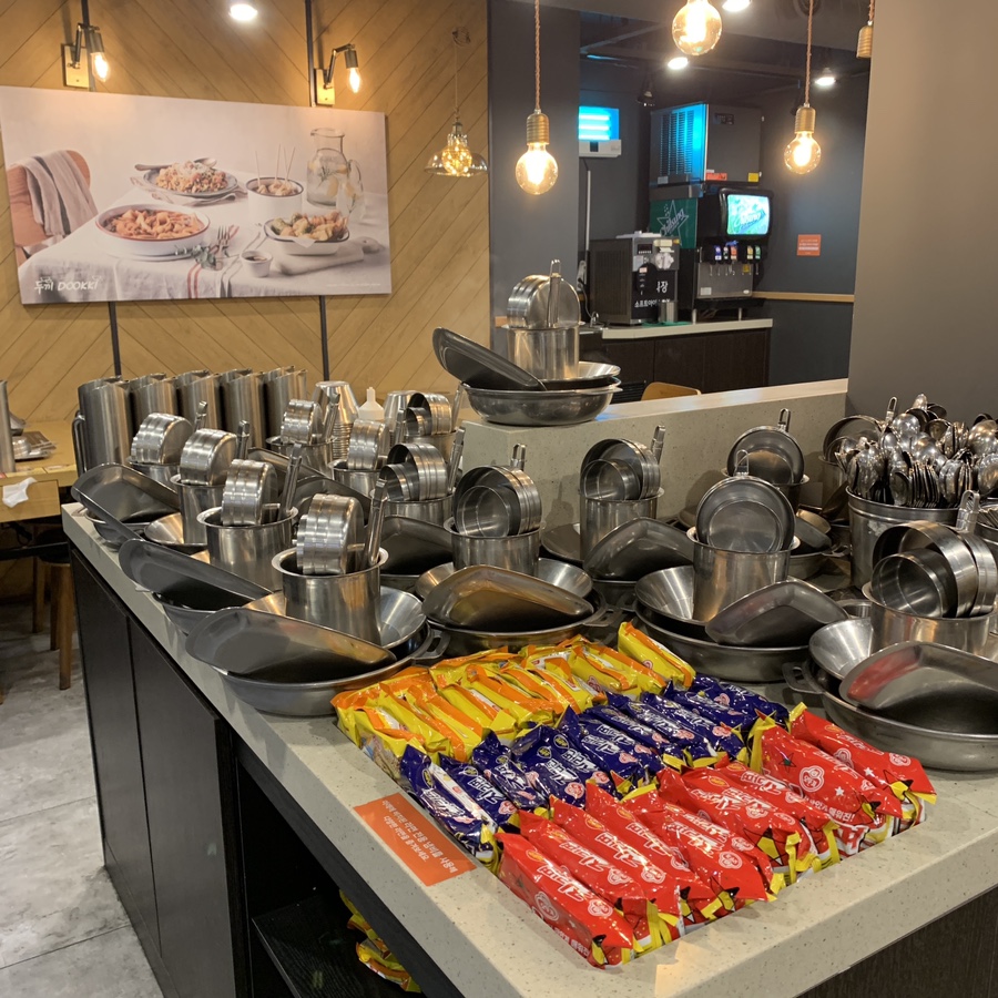 dookki tteokbokki buffet in seoul table setup with dishes and instant noodles