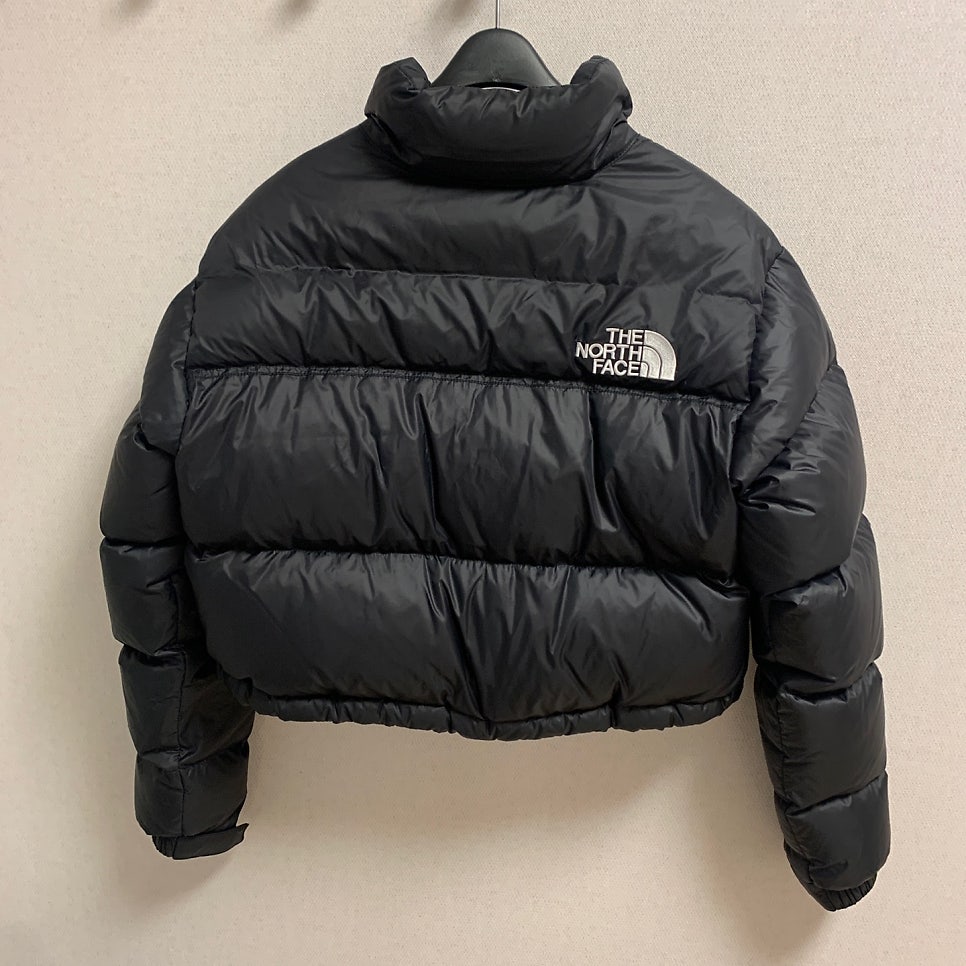 the north face nuptse short jacket black back view cropped fit and puff design