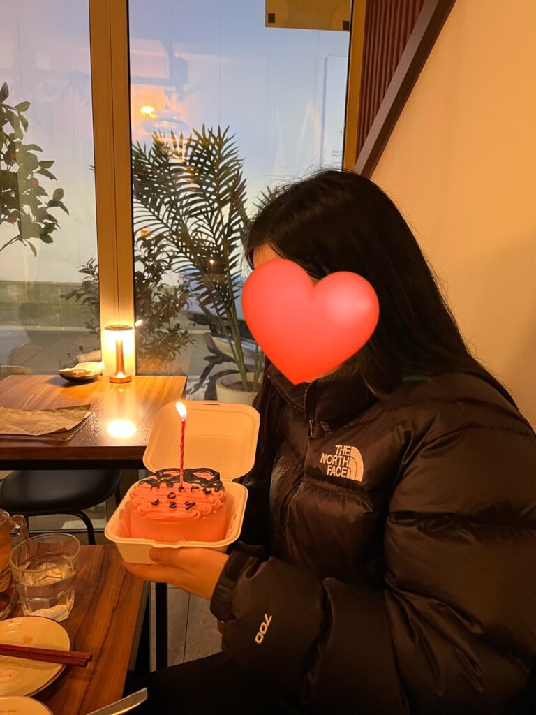 the north face nuptse short jacket indoor cozy winter vibe holding cake