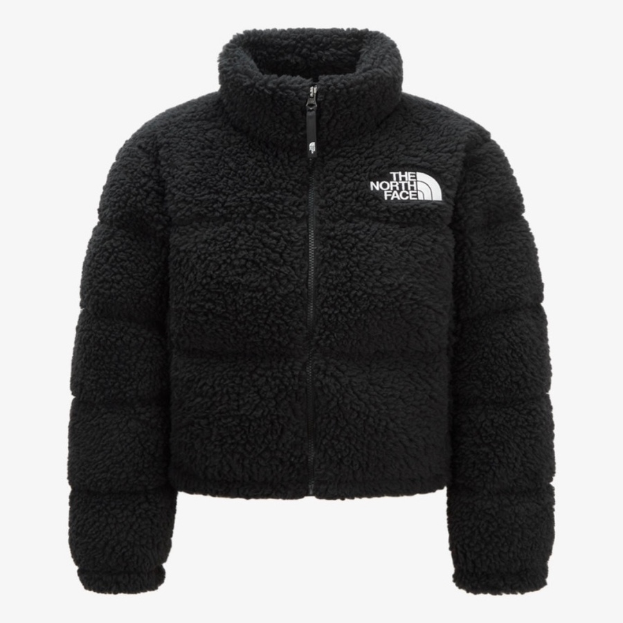 The North Face Sherpa Nuptse Jacket in black β official image showing fluffy texture and white logo on chest.