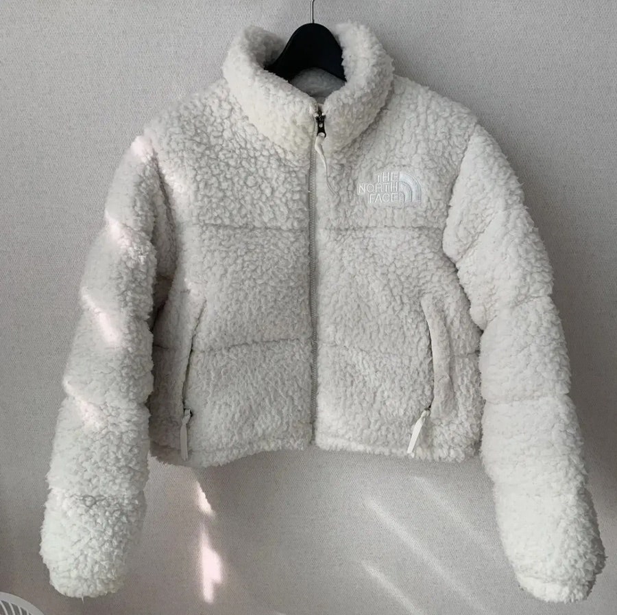 Close-up texture of The North Face Sherpa Nuptse Jacket White showing fluffy fleece and cozy fabric