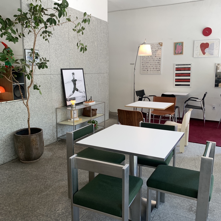 Minimalist interior of Seokchon Station Cafe Meek with green chairs