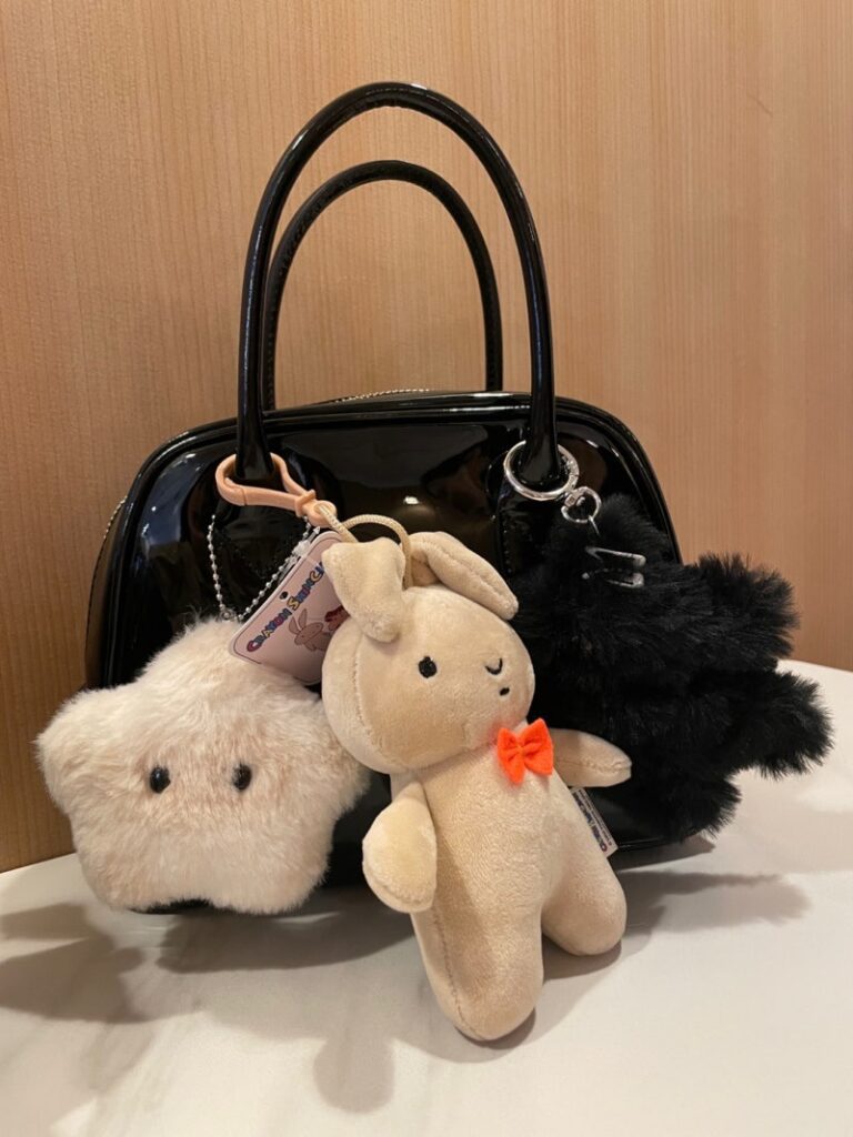 comme des garcons aoyama bag decorated with plush keyrings