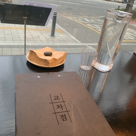 Gyocajum Seokchon Station Tonkatsu bar table setup with water bottle