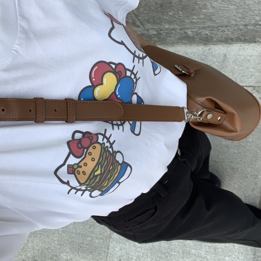 Hello Kitty Uniqlo T-shirt M size styled with black pants and brown crossbody bag