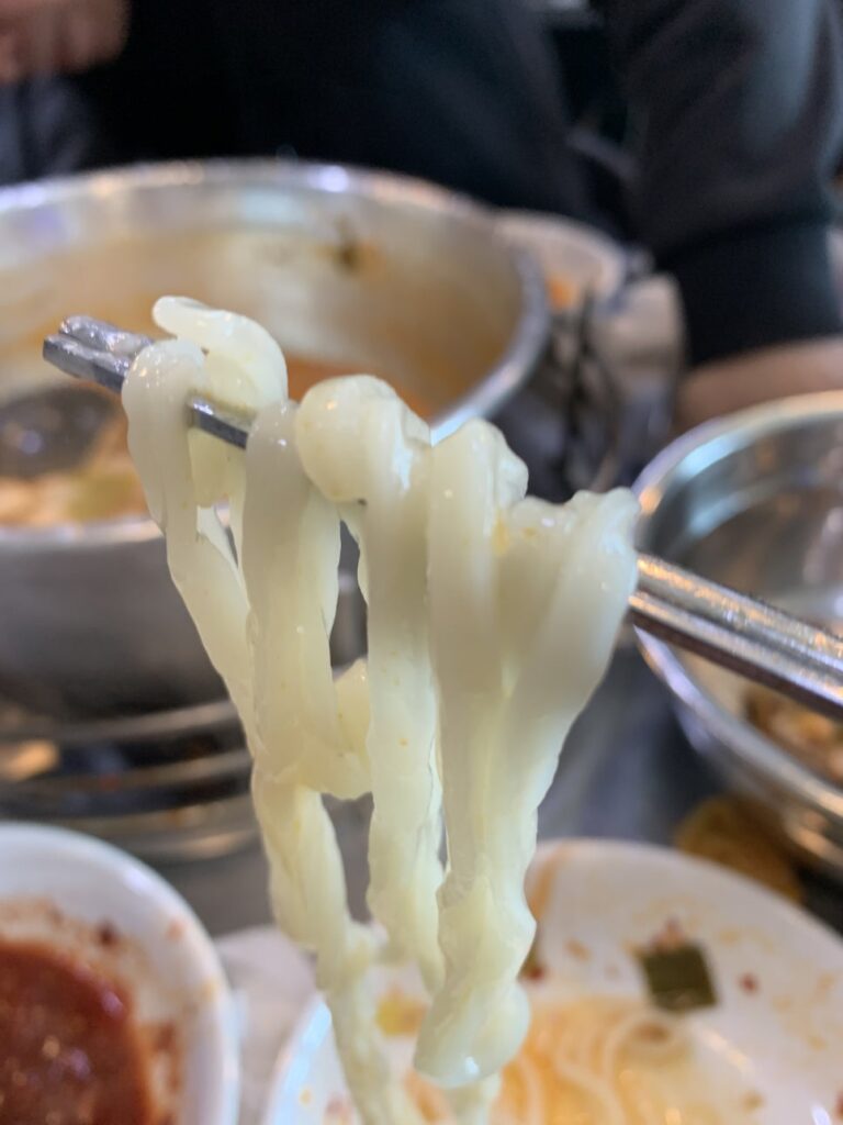 Chewy noodles lifted in Dongdaemun Dakhanmari soup