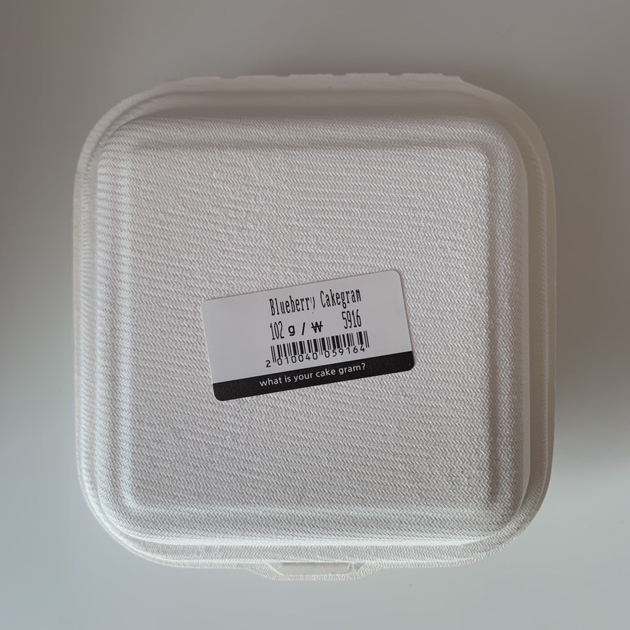 Packed cake cup with barcode showing grams and price