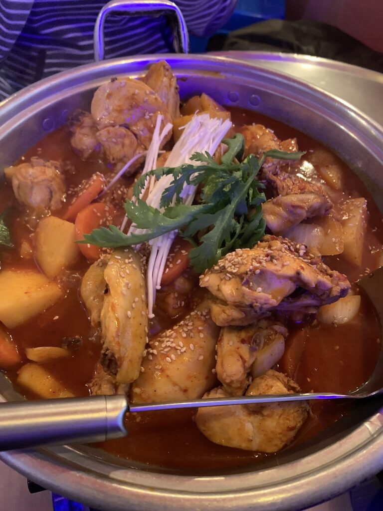 close-up of Korean spicy braised chicken with vegetables near Seokchon Lake