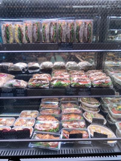 Variety of sandwiches at Paris Croissant Gangnam Station neatly arranged in refrigerator showcase