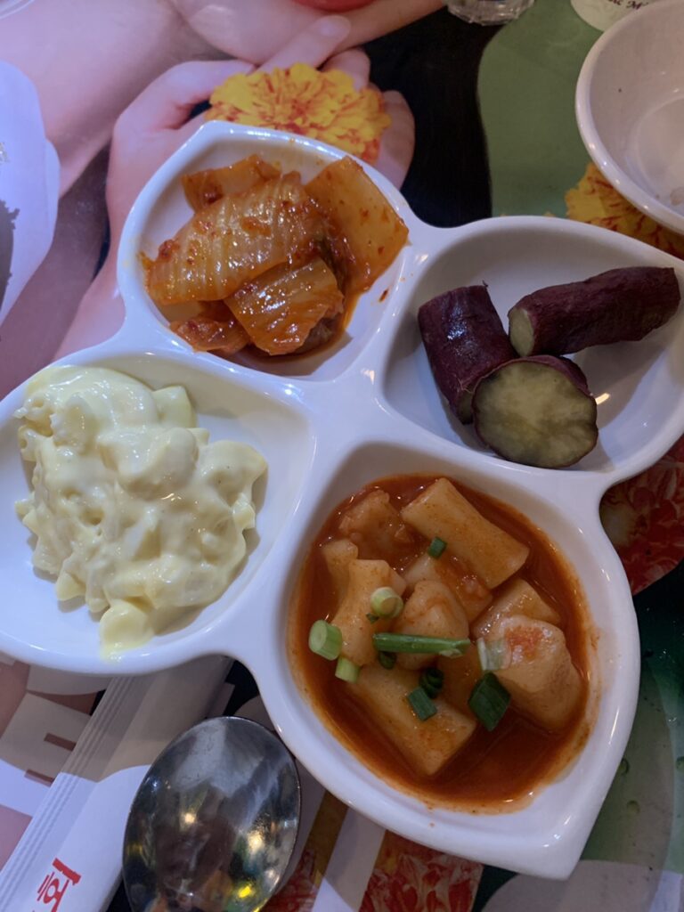 Side dishes at Matzzang Jogae Gangnam including macaroni salad and tteokbokki