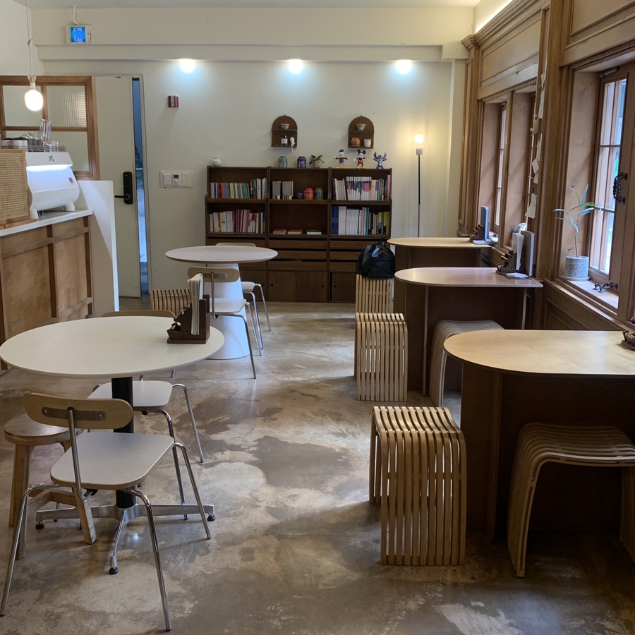 Cozy interior with wooden tables and chairs at Cafe Root Gangnam