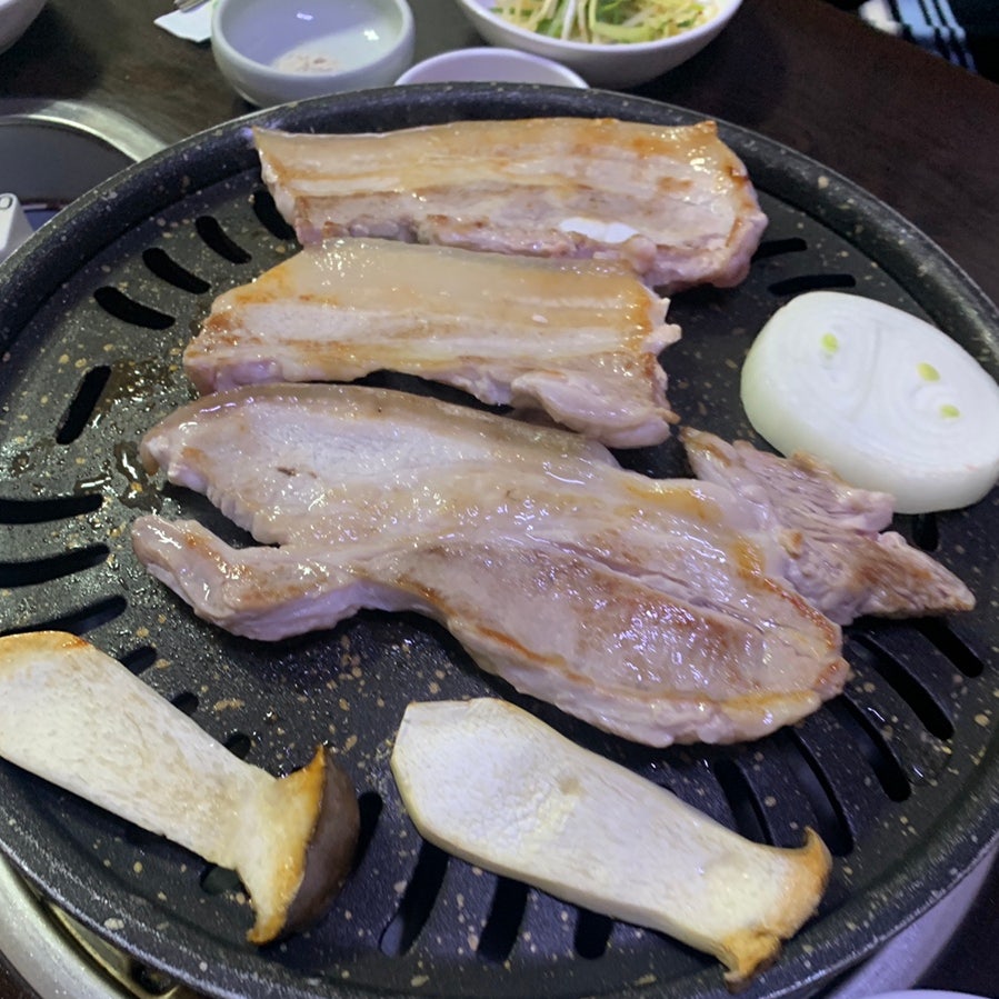 Grilled pork belly on a table grill at a Bukchon Korean Restaurant