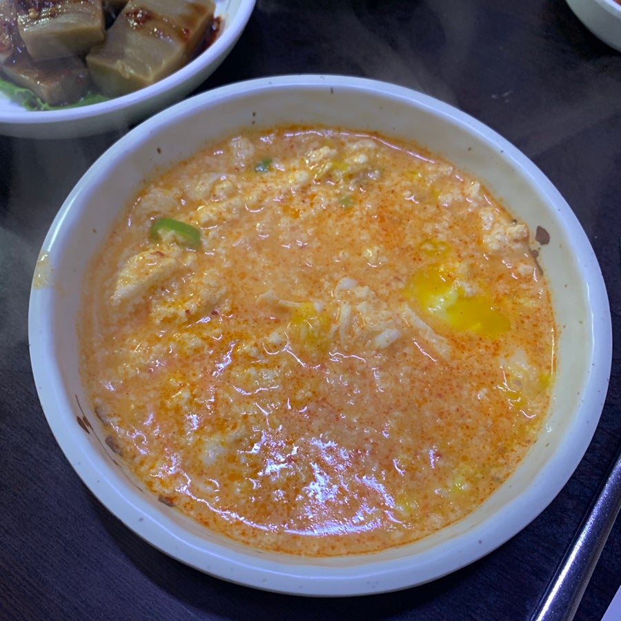 Korean seafood sundubu stew served in a bowl at Jaedong Sundubu in Bukchon