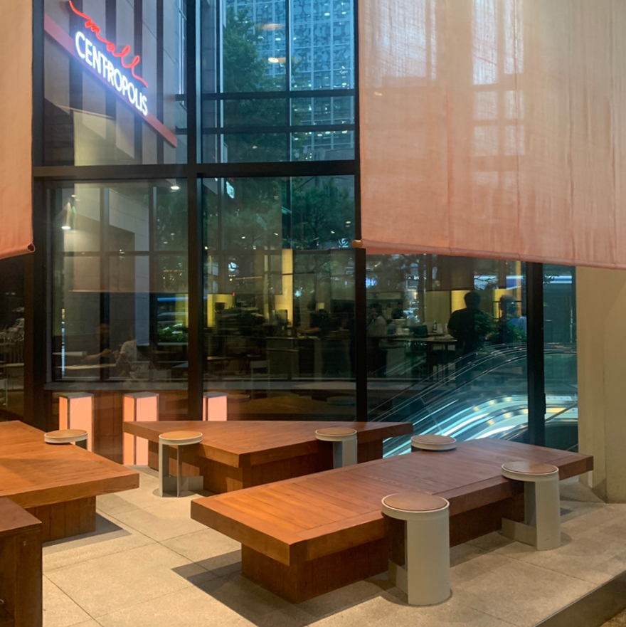 Wooden bench seating near large windows at Gyeol Cafe Jongno