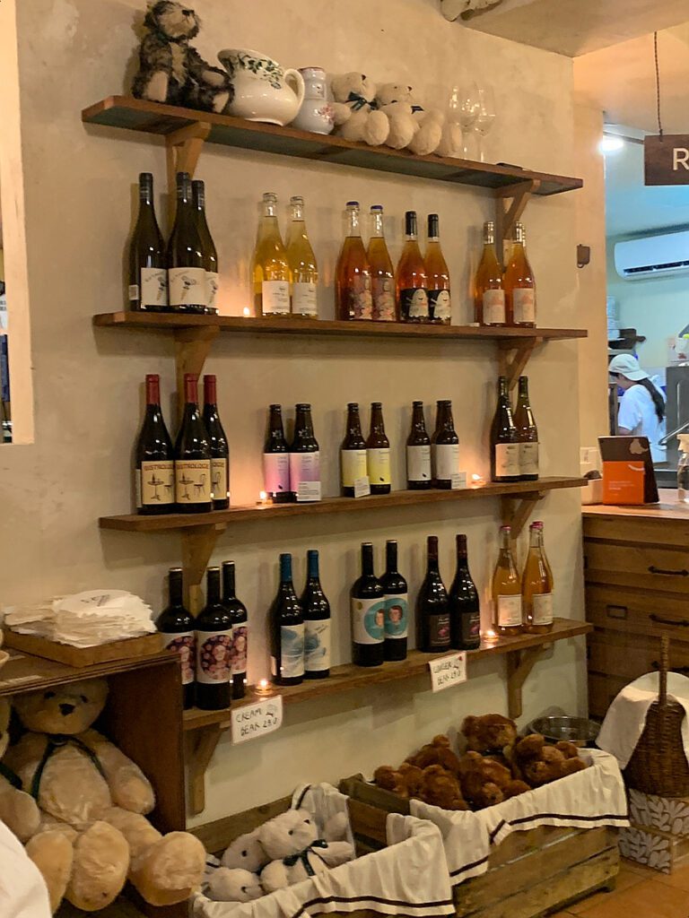 Wine bottles and teddy bear decor at this Songridan-gil Jamsil dessert cafe