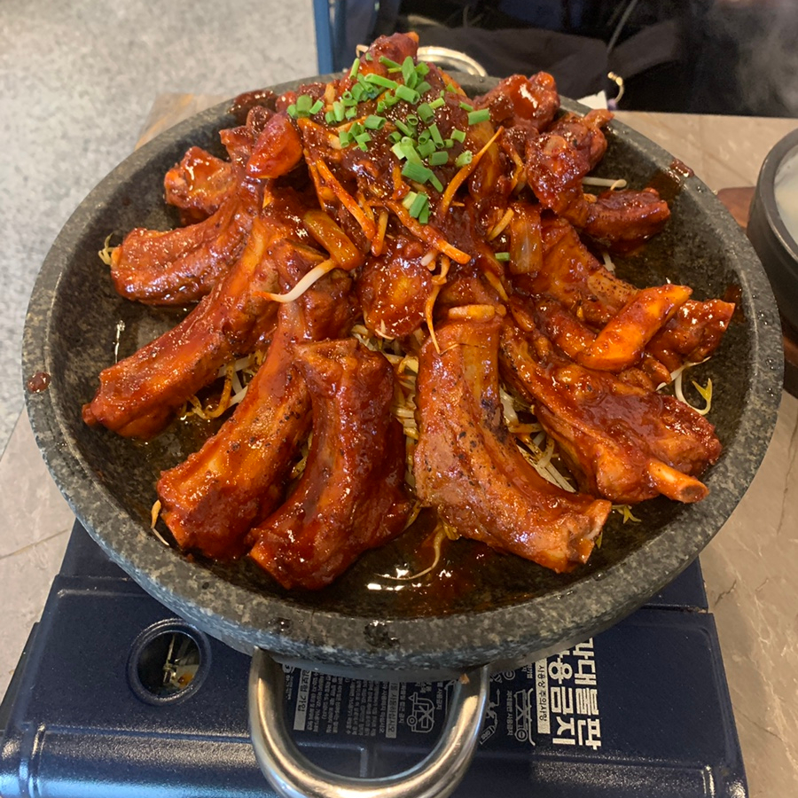 Spicy pork ribs served on a hot stone pan at a Hyehwa Korean restaurant