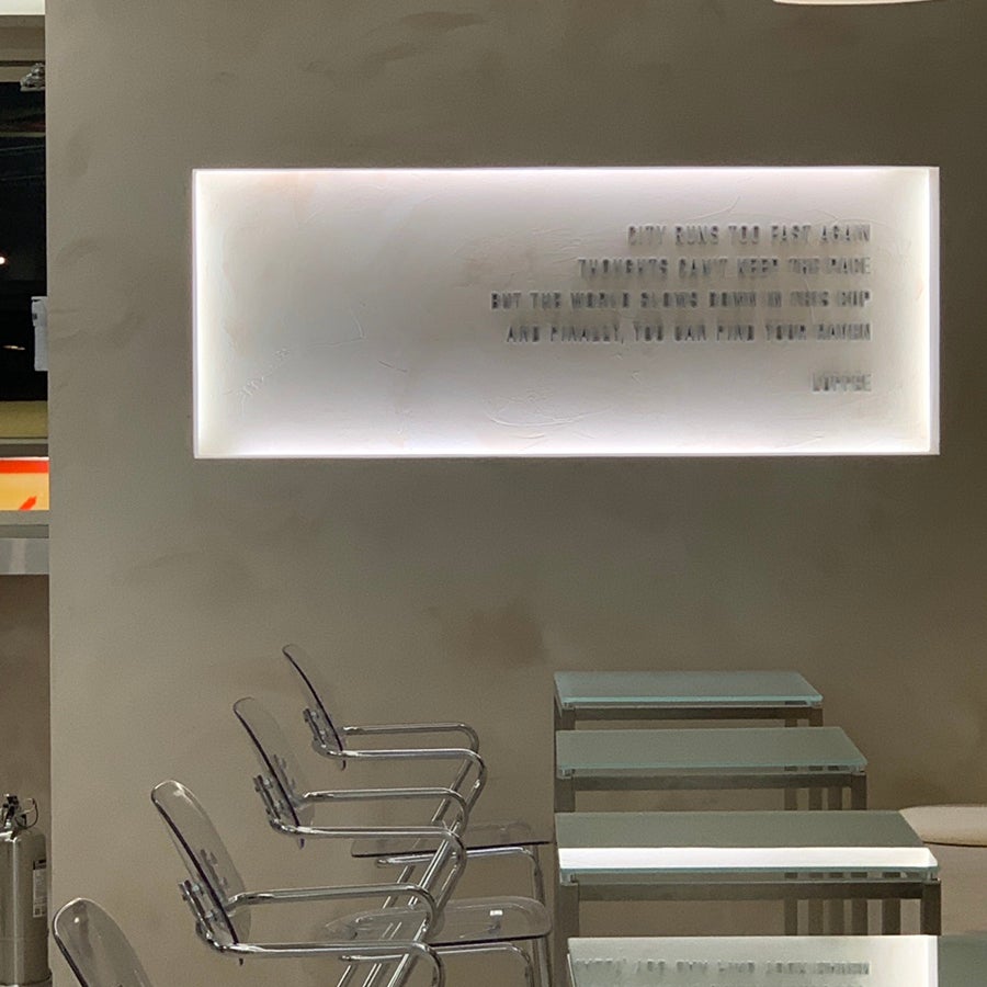 minimal interior seating area with soft neon panel lighting