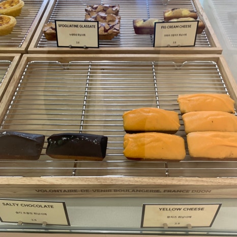 dessert display with yellow cheese financiers and chocolate bars