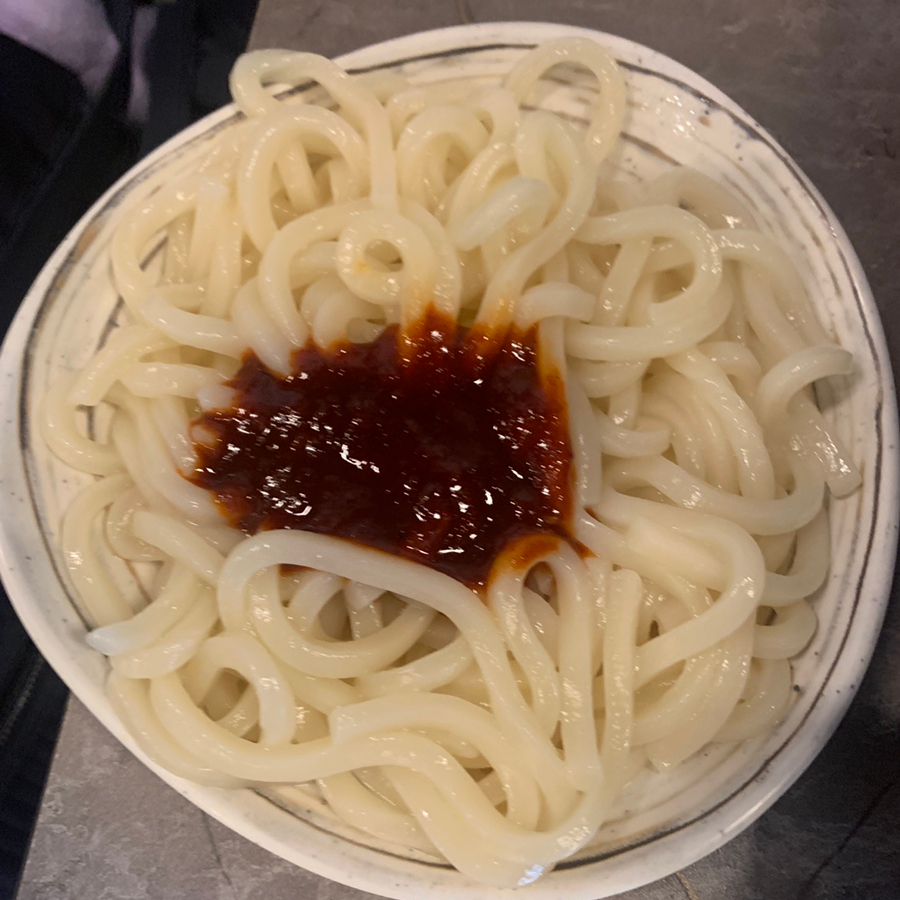 Plain udon noodles ready to be mixed with spicy sauce at Gobongdang in Hyehwa