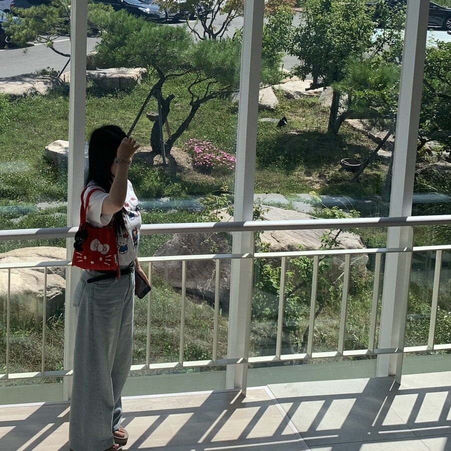 UNIQLO Hello Kitty Custom T-shirt outfit with red Hello Kitty tote bag on a sunny day