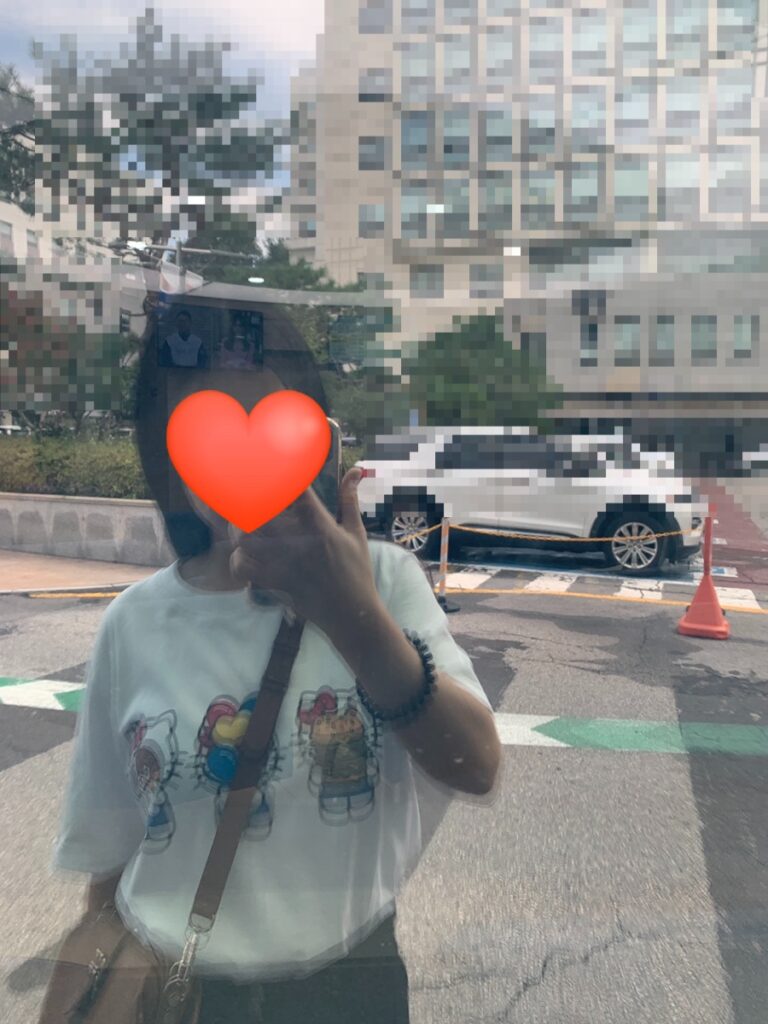 Mirror selfie wearing Hello Kitty Uniqlo T-shirt casual street look