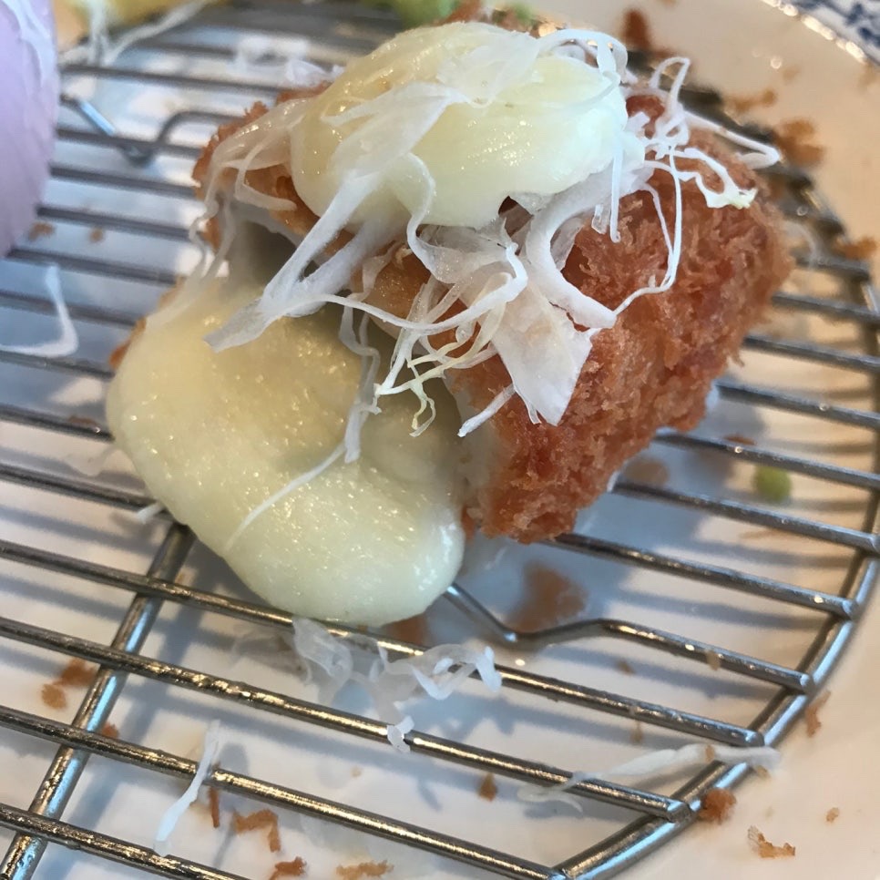 Close-up of cheese cutlet showing melted cheese stretching out