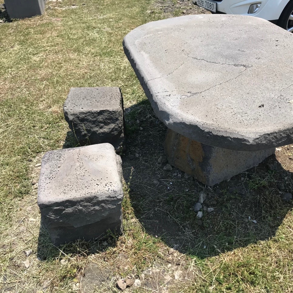 Stone table and chairs outside the restaurant showing Jejuβs traditional vibes