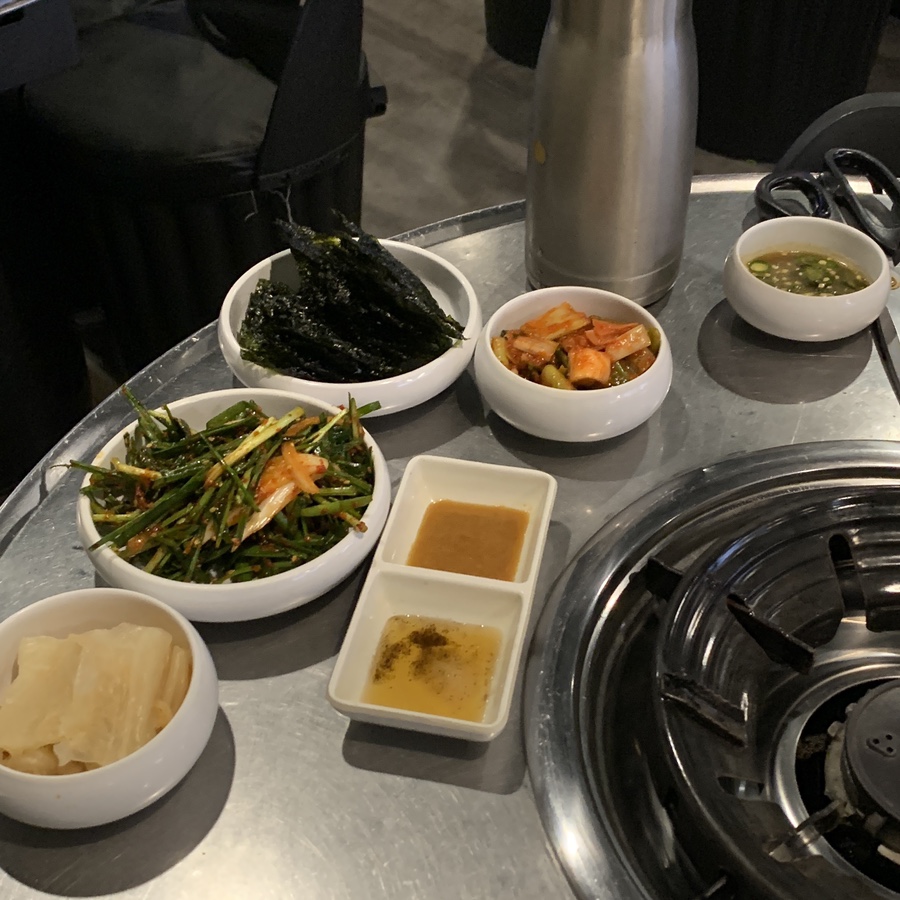 Korean side dishes including chives, seaweed, washed aged kimchi and sauces at Jingu Gopchang — Gangnam Gopchang
