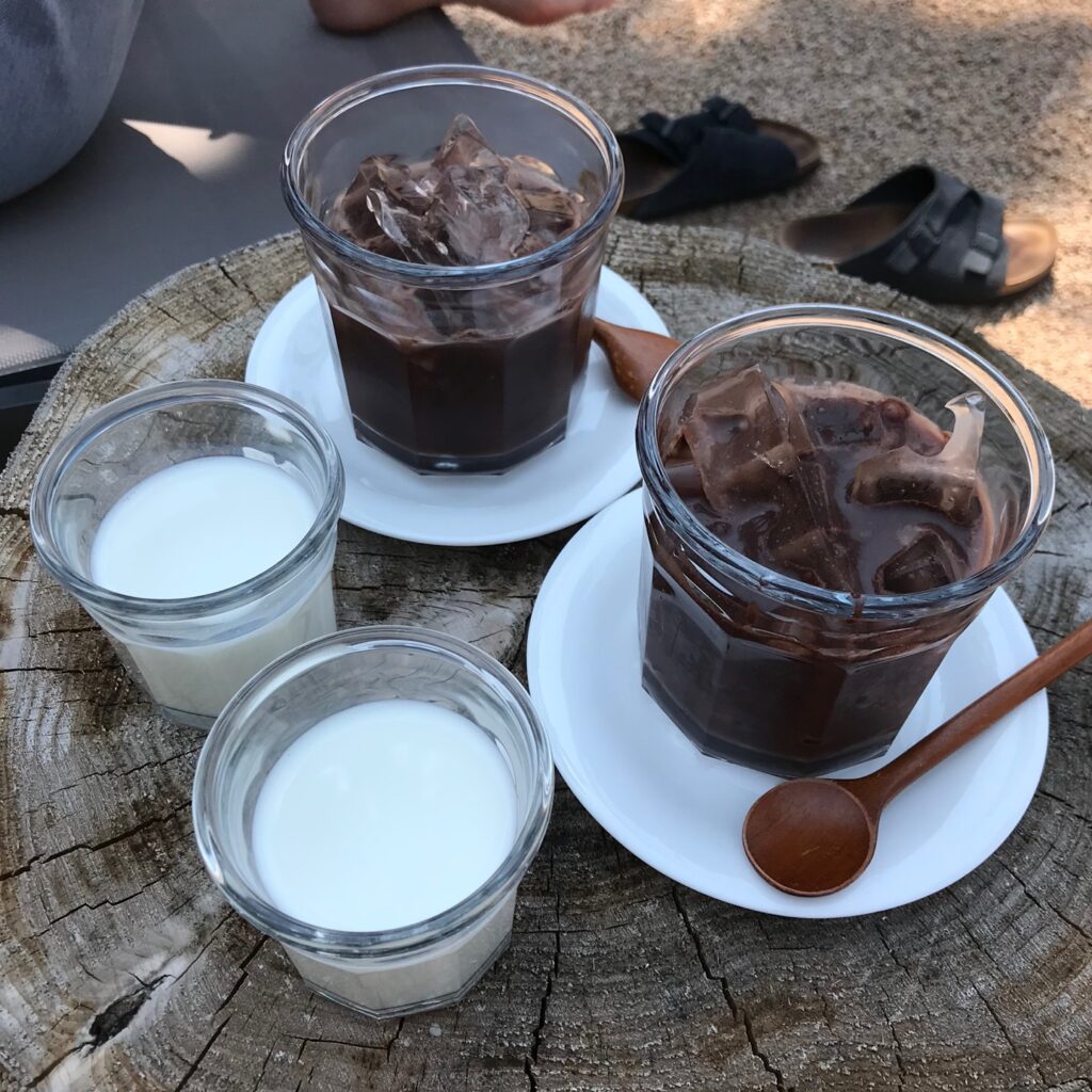 iced chocolate and milk served at Jeju Cafe Costeño on wooden table