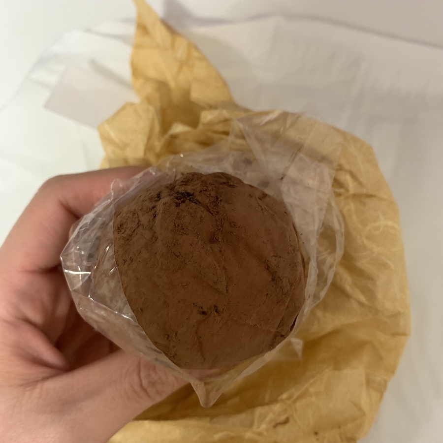 Whole strawberry Dubai mochi dusted with cocoa powder at a dessert shop in Seongsu