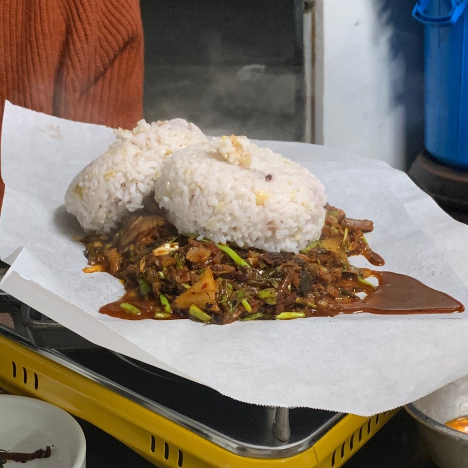 Rice added to leftover kimchi and pork fat for fried rice at Hansung Sikdang