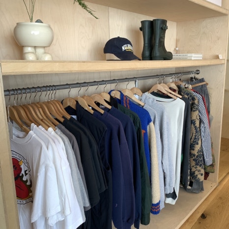 Dosan Park Waste Store Cafe curated clothing rack with graphic apparel and vintage items