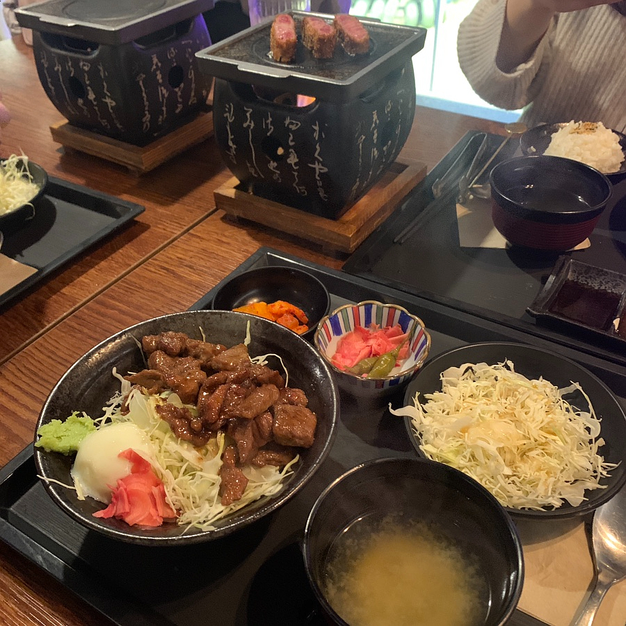 Medium-rare gyukatsu cooked on a tabletop charcoal grill at Furato Shokudo Shinsa