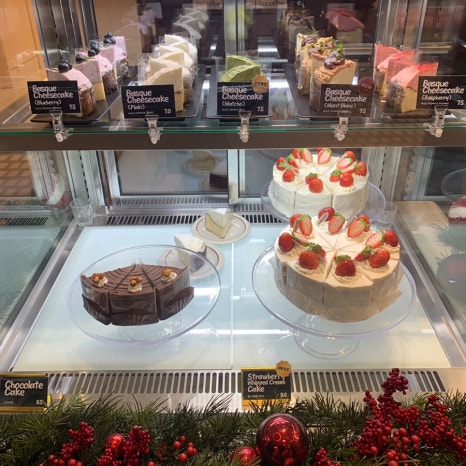 Cheesecake showcase with various flavors at JM Coffee Sinsa Lounge