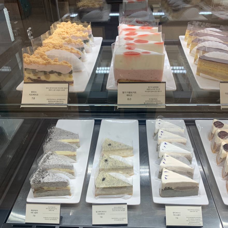 cake display at Seoul Express Bus Terminal cafe with various cheesecake and dessert options