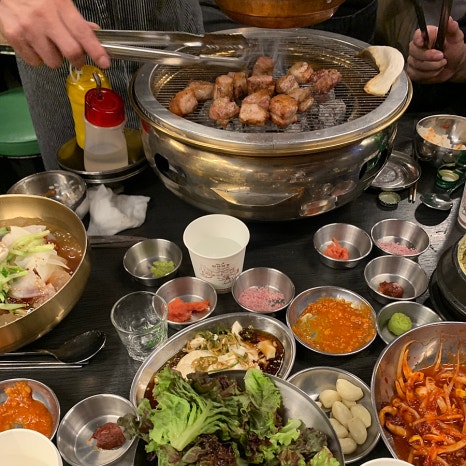 Full Korean BBQ table with charcoal grill Euljiro Korean BBQ Seoul