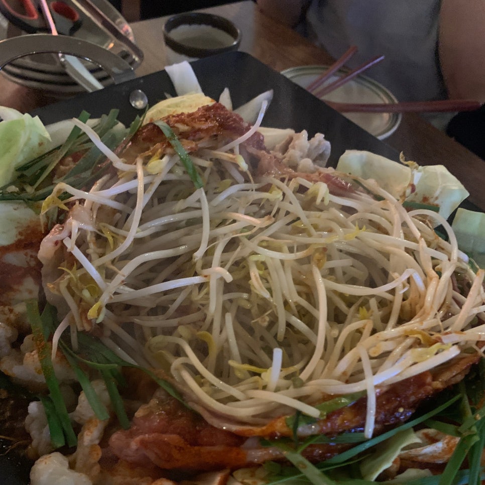 Osakaya nabe cooking on a hot plate with pork and bean sprouts in a Japanese izakaya