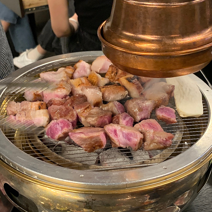Cube pork neck grilling on charcoal Euljiro Korean BBQ
