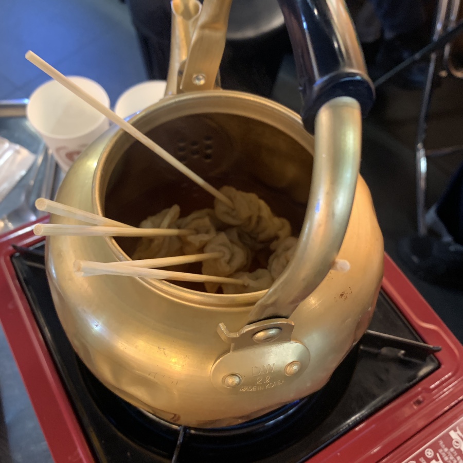 korean fish cake skewers served in kettle eomuk soup