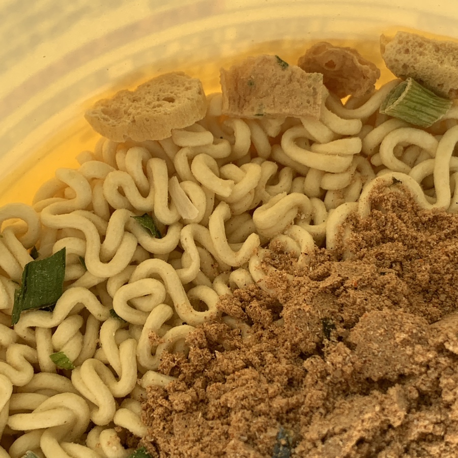instant ramen noodles seasoning powder fish cake flakes close up