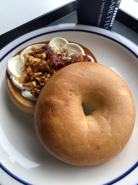 City Hall cafe Seoul chili bagel with cream cheese and nut toppings close up