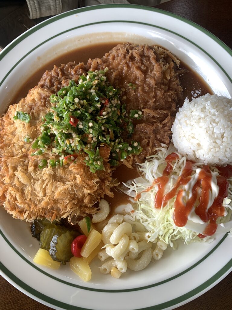 Pork cutlet topped with chopped green chili peppers