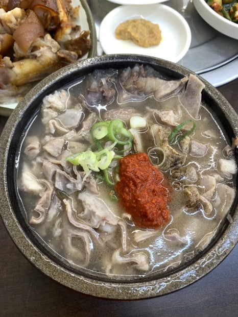 Korean pork blood sausage soup with rice and green onions in hot broth bowl