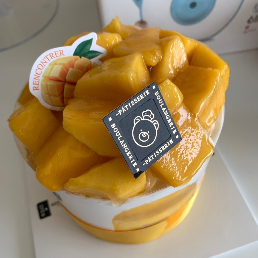 Close-up mango cake with diced fresh mango and cream dessert