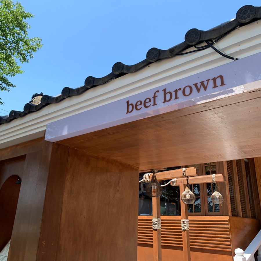 Exterior view of Beef Brown Ulsan Korean BBQ restaurant with wooden traditional-style entrance