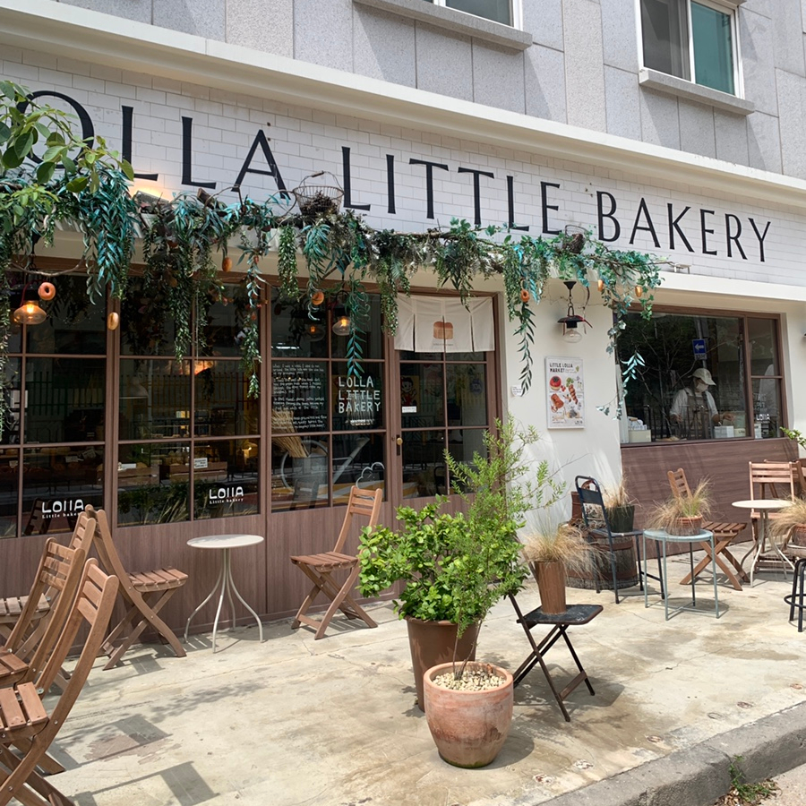 Lola Bakery Daejeon exterior storefront Little Bakery sign with outdoor seating and greenery café entrance