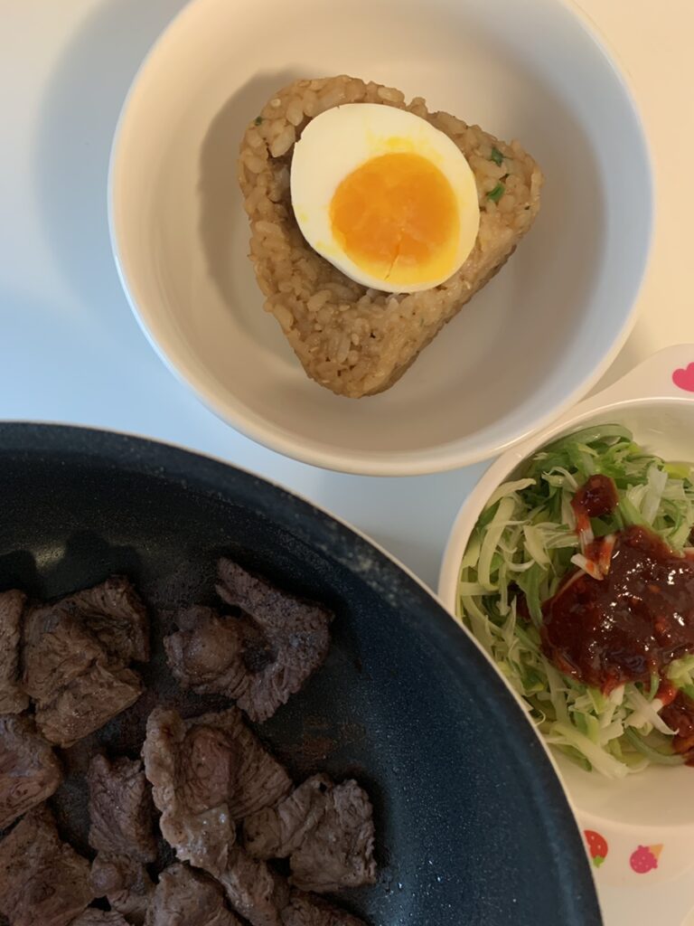 Half-Boiled Egg Rice Ball served with grilled beef and salad
