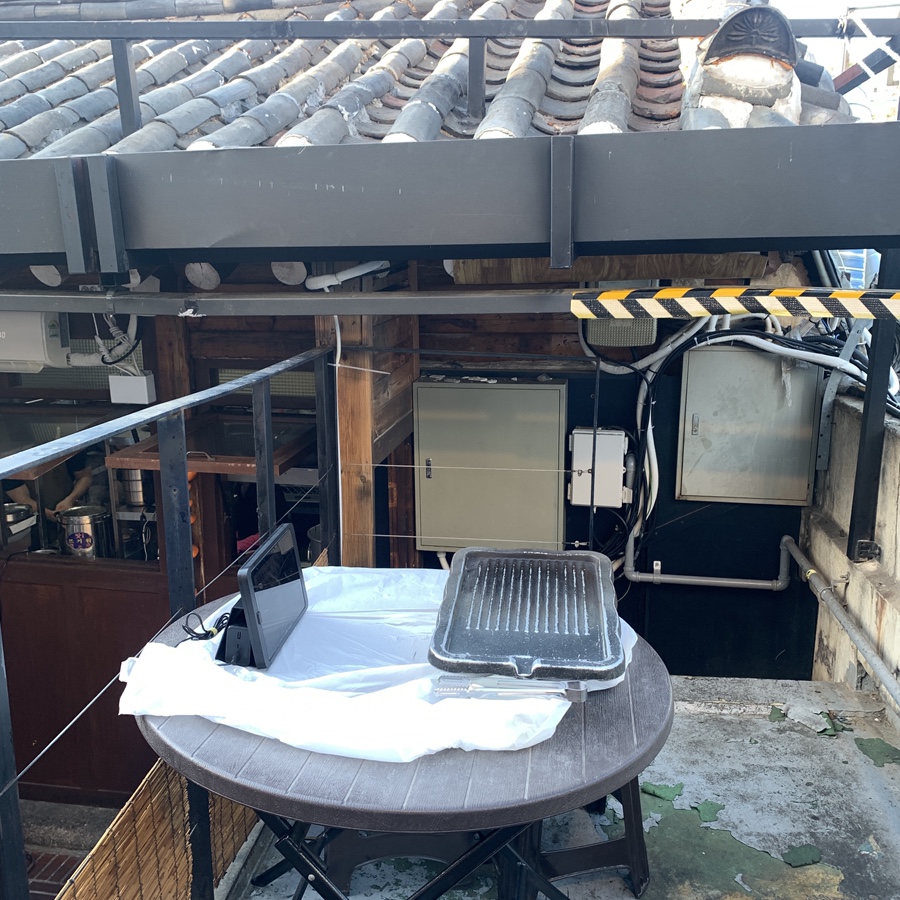 Outdoor Korean BBQ table in a traditional Ikseondong hanok setting
